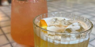 Image of two pink and yellow drinks.