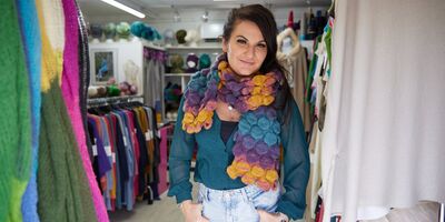 Image of Joanne wearing her scarf in her shop.