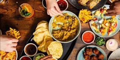 Image of people eating food at a table.