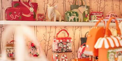 Shop shelves lined with colourful leather bags