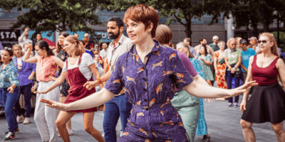 A photo of a group of people captured dancing.