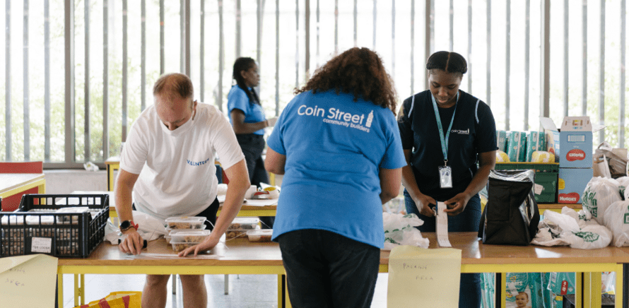 Staff and volunteers packing food and supplies in the food hub at our neighbourhood centre