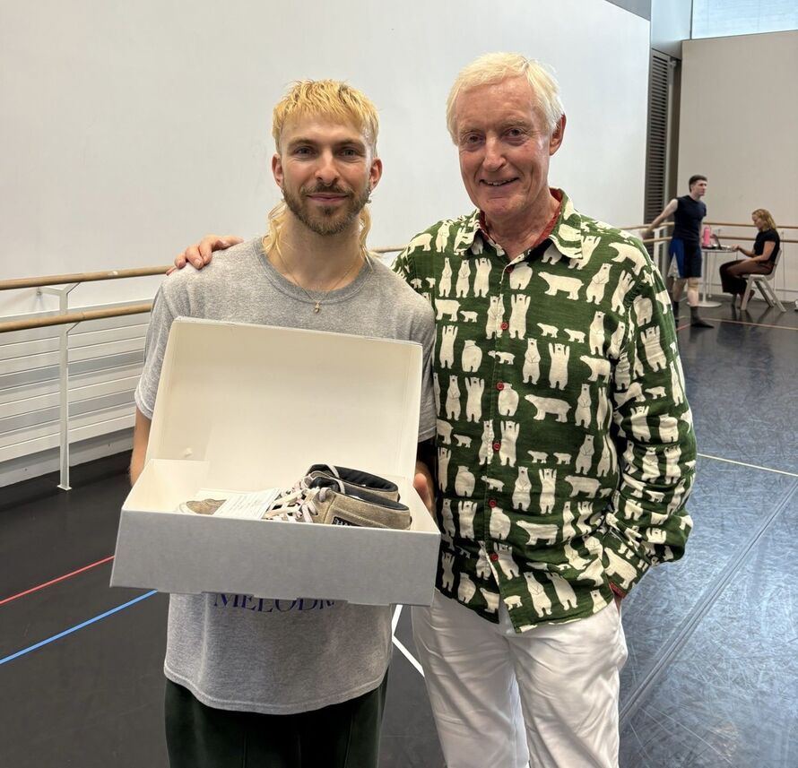 Dylan Tadaldi holding the shoes for  and Iain Tuckett