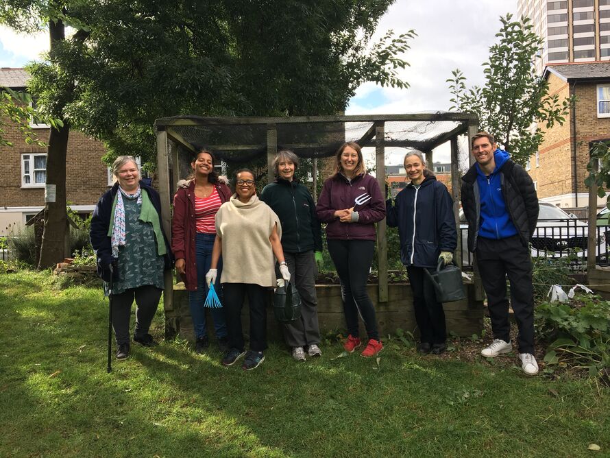 Gentle gardening group stood in front of plant beds