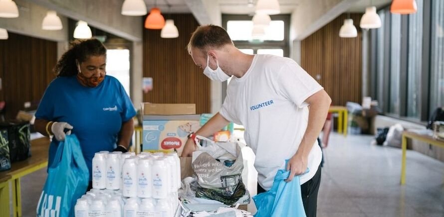Volunteers packing up food and supplies to deliver to local residents in need